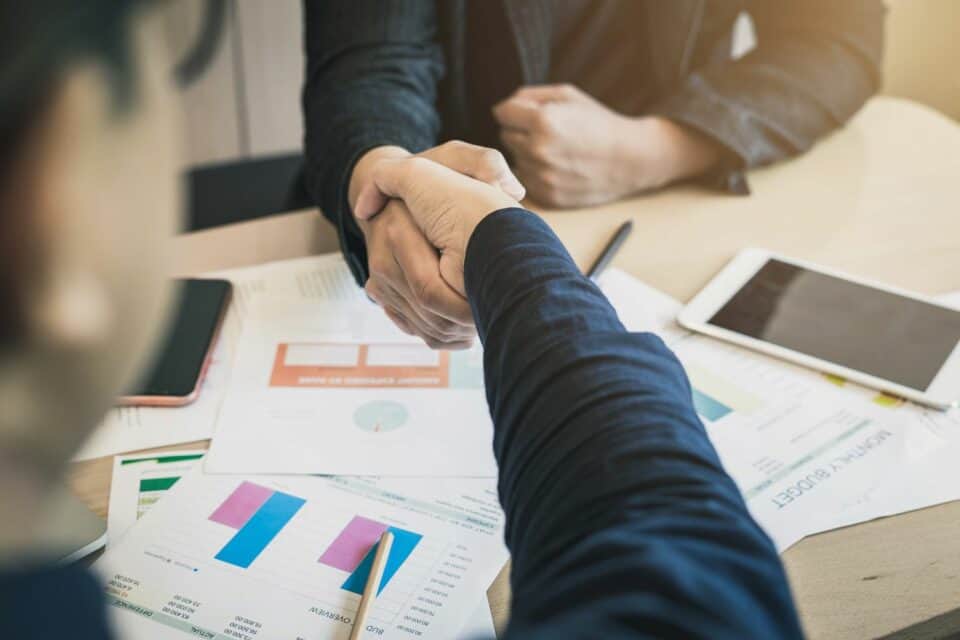 Two Businessmen shaking hand Agreement Partnership